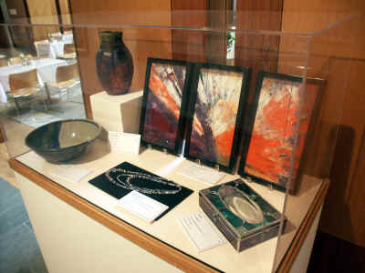 Paul Dungan Large Bowl; Jenny Ditto Blue Raku (vase); Donald R Ricker Pallette Triptych II; Marie Bader Alyeska Secret (necklace); Liz Bowen Icarus (glass box) under glass at the AMRC